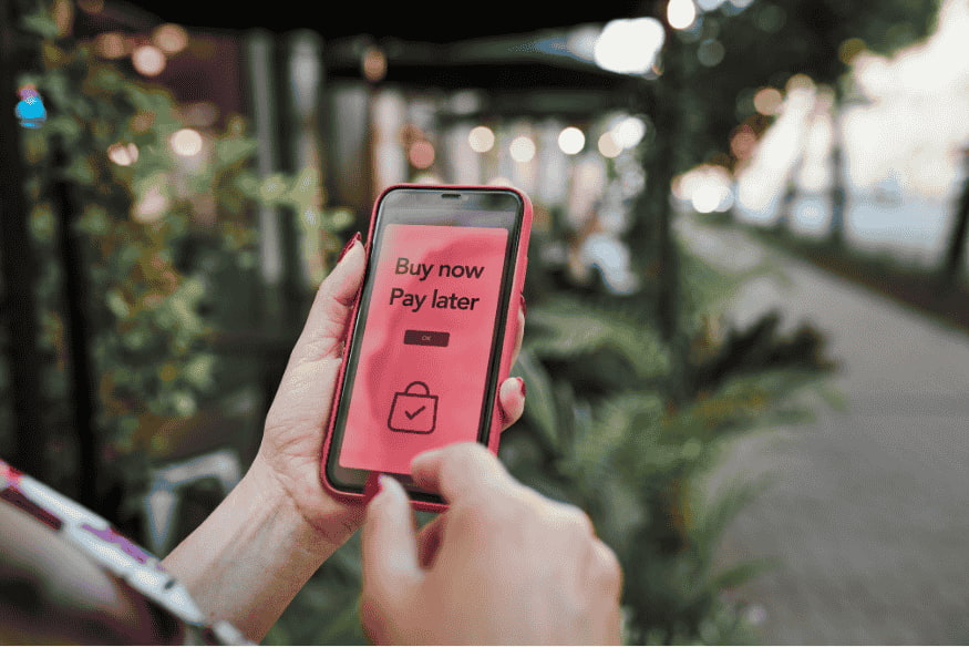 Smartphone screen showing Buy Now Pay Later option during a purchase as a symbol of installment payments and short-term financing