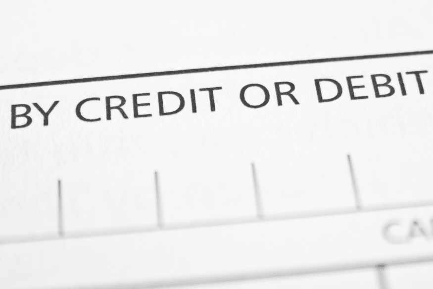 Close up of a payment form with the words “by credit or debit,” highlighting the choice between card types.