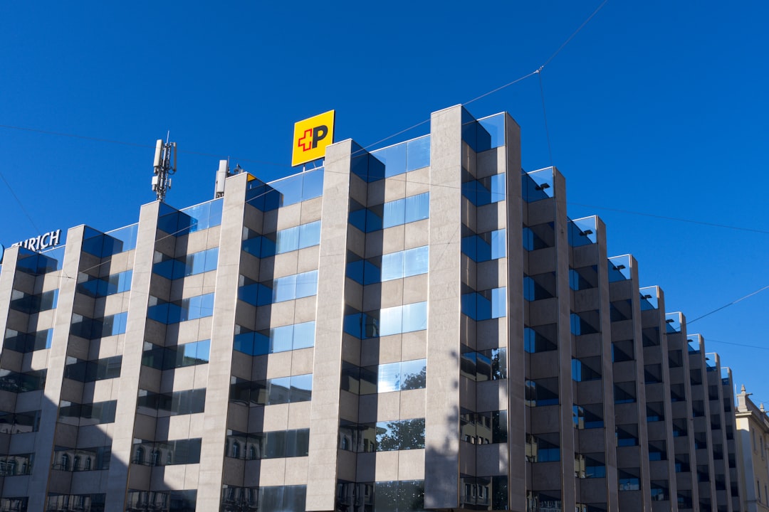 Modern office building with blue sky and yellow sign