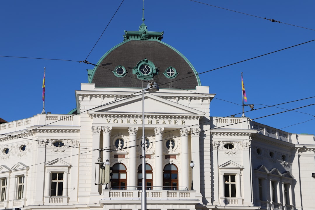 a large white building with a green dome on top