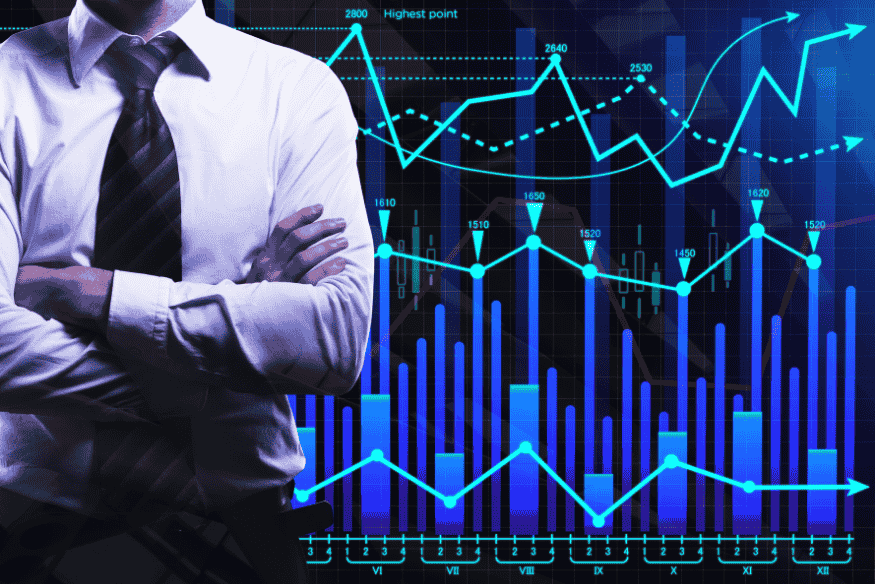 Professional standing in front of digital financial charts symbolizing advanced finance tools for freelancers