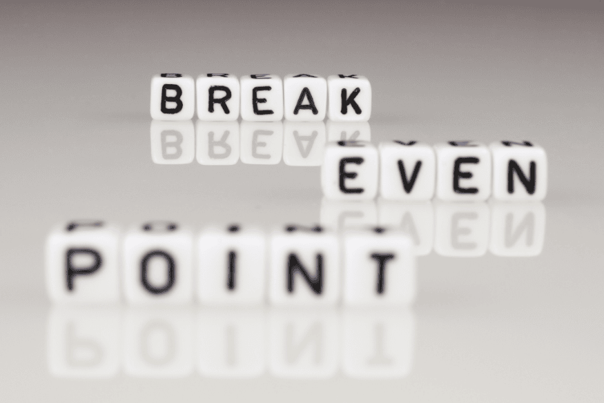 Break even point written with letter blocks symbolizing the concept of personal break-even in budgeting