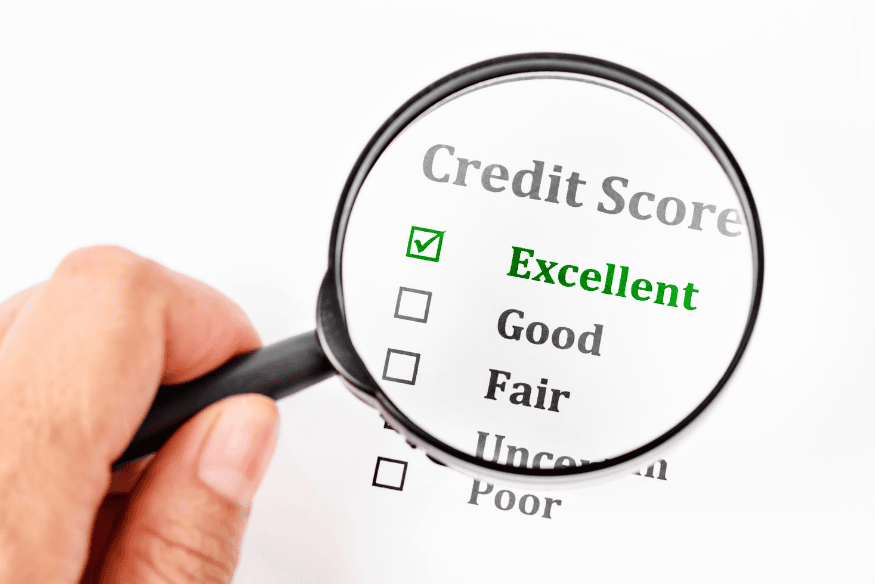 Magnifying glass highlighting an excellent credit score checklist when choosing the best credit card for your profile.