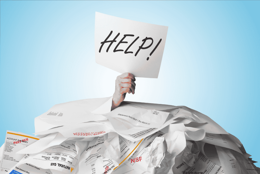 Person buried under unpaid bills holding a “HELP!” sign, symbolizing the need to organize personal finances and escape debt.