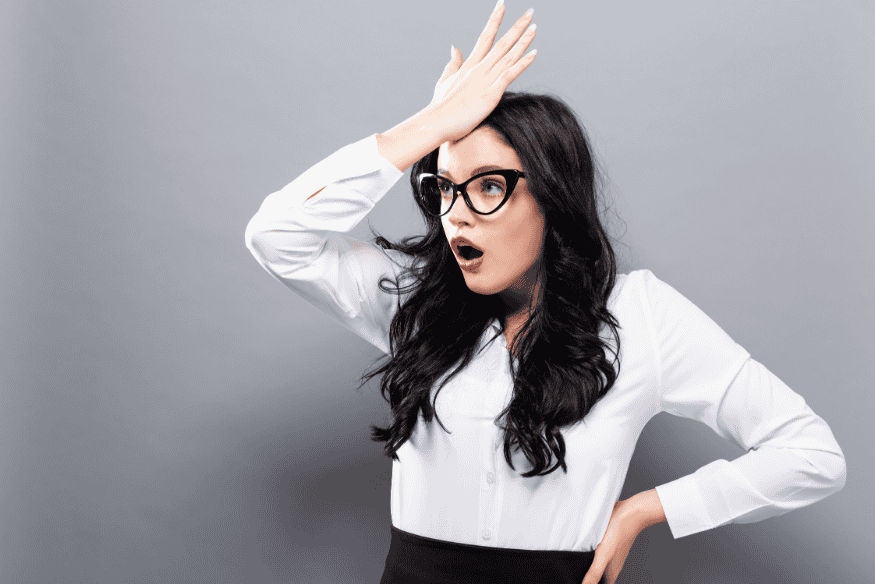 Young woman facepalming after realizing a financial mistake in her 20s.