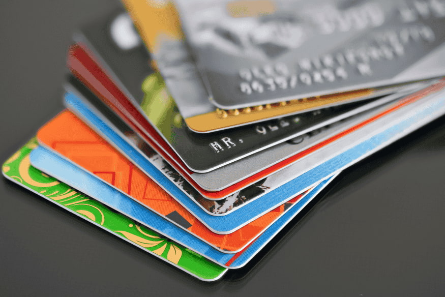 Stack of colorful credit cards representing different secured credit card options.