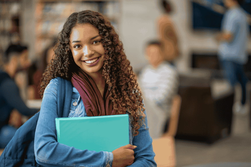 Happy university student on campus after being approved for a student credit card