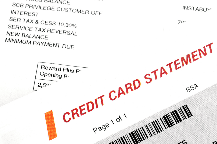 Close-up of a credit card statement showing balances, charges and fees.