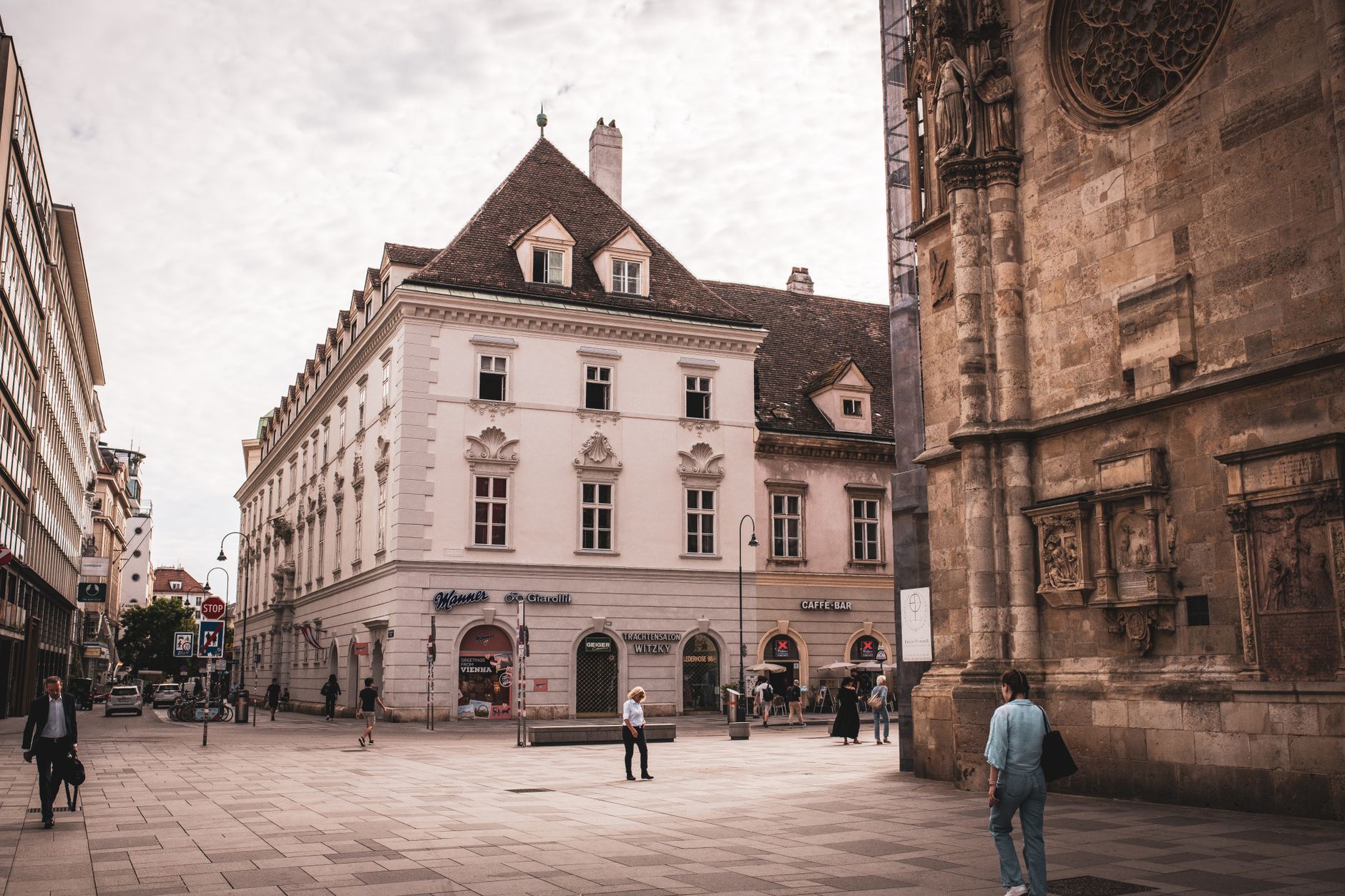 A quaint European street surrounded by historic architecture, capturing city life.